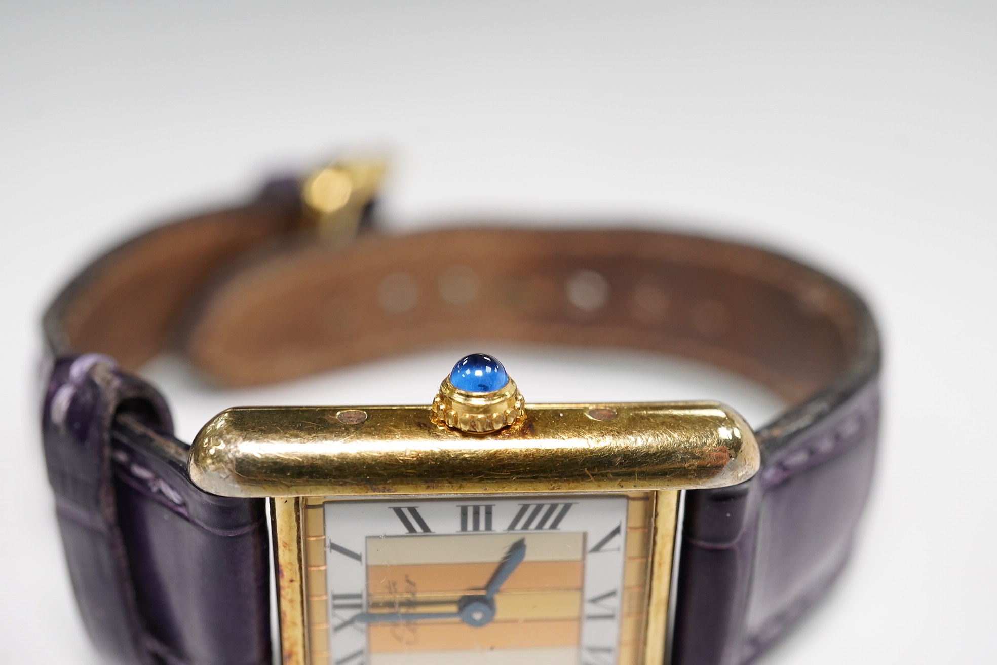 A lady's Cartier Vermeil Tank gilt 925 quartz wrist watch, with cabochon sapphire set crown and Cartier leather strap, cased diameter 20mm, no box or papers. Condition - poor to fair